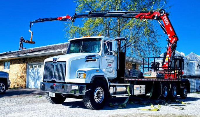 Crane delivering roofing supplies